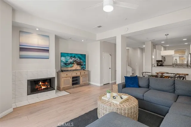 a living room with furniture a flat screen tv and a fireplace