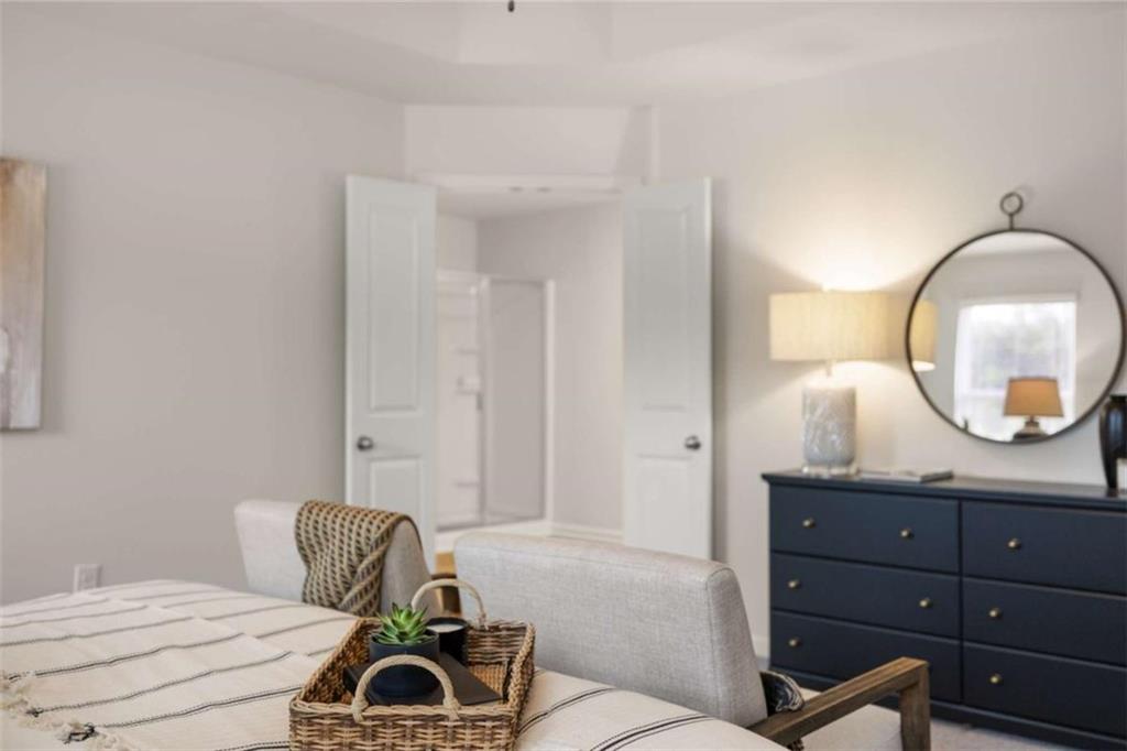 1039 Merritt Drive, Unit 92 Villa Rica, GA 30180 - Photo 27 of 47 a bedroom with a bed and a mirror