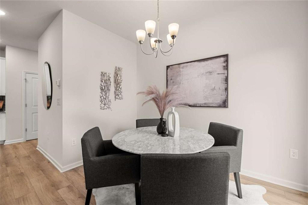 1039 Merritt Drive, Unit 92 Villa Rica, GA 30180 - Photo 39 of 47 a dining room with furniture and chandelier