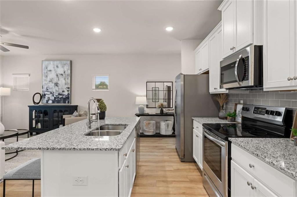 1039 Merritt Drive, Unit 92 Villa Rica, GA 30180 - Photo 42 of 47 a kitchen with stainless steel appliances granite countertop a sink stove and refrigerator