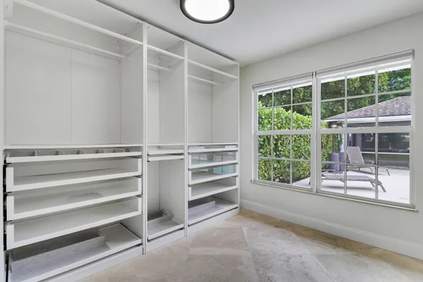 a view of walk in closet with empty racks