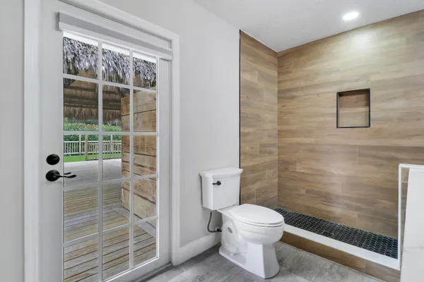 a bathroom with a toilet and a shower