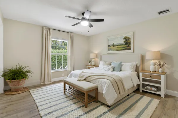 a bedroom with a bed and a potted plant