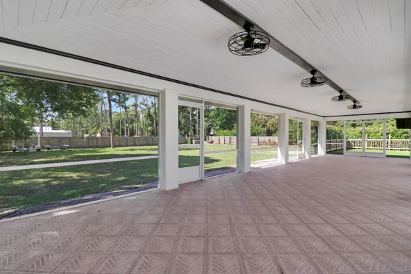 a view of a porch with furniture and garden