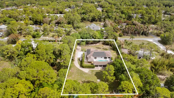 an aerial view of a pool patio outdoor seating and yard