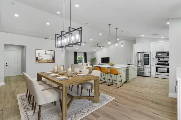 a large kitchen with a table and chairs