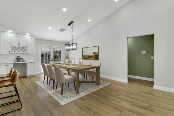 a view of a dining room with furniture and wooden floor