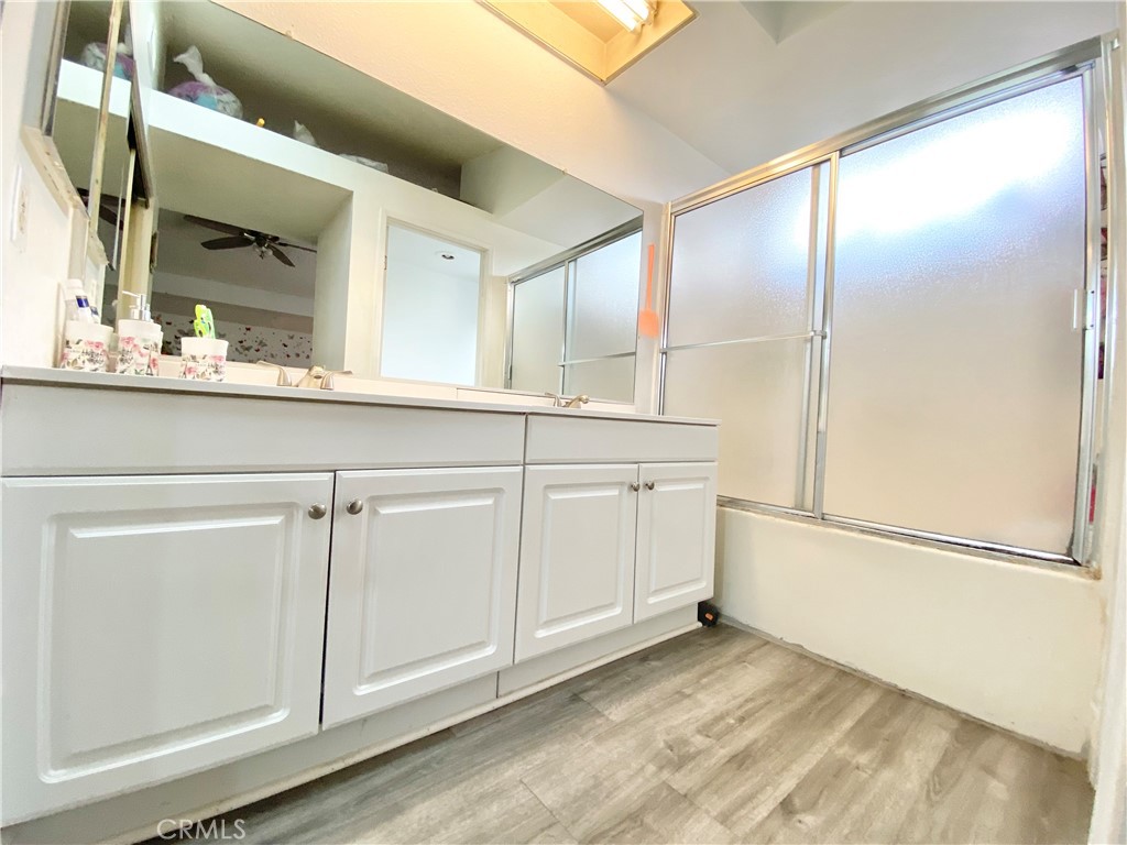 1444 North Sage Avenue Rialto, CA 92376 - Photo 16 of 22 a view of a kitchen with wooden floor and cabinets