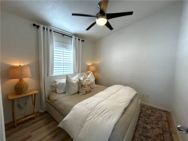 a bedroom with a bed and a painting on the wall