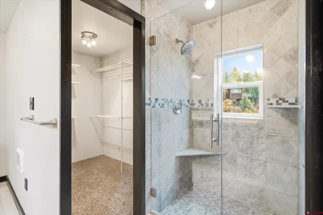 an empty room with a window and a ceiling fan