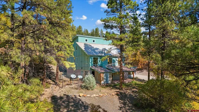 a view of a balcony with two plants and a bench