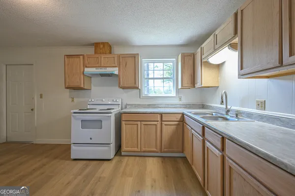 a kitchen with stainless steel appliances granite countertop a sink stove and cabinets