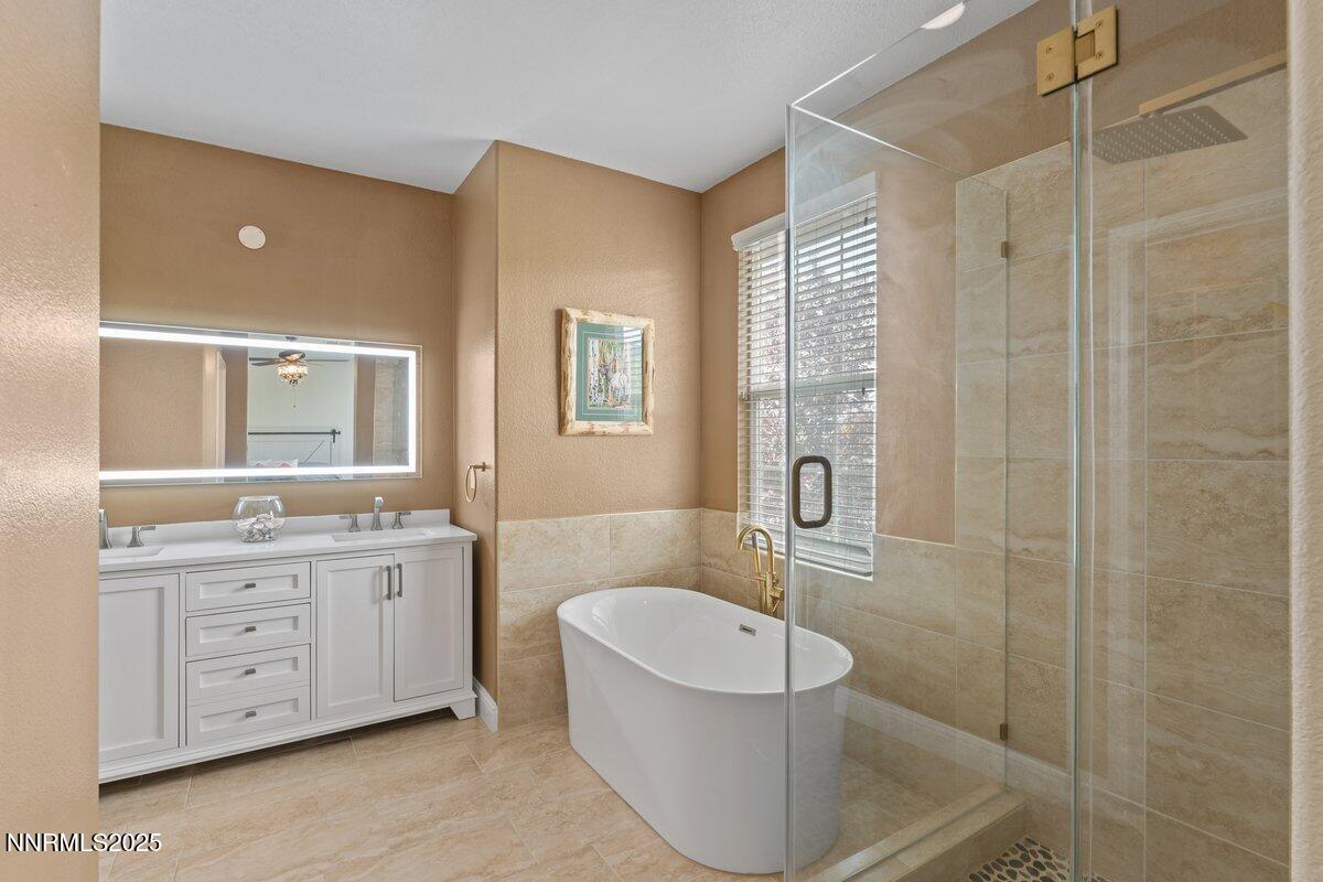 1955 Wind Ranch Road, Unit A Reno, NV 89521 - Photo 13 of 23 a bathroom with a double vanity sink toilet and shower