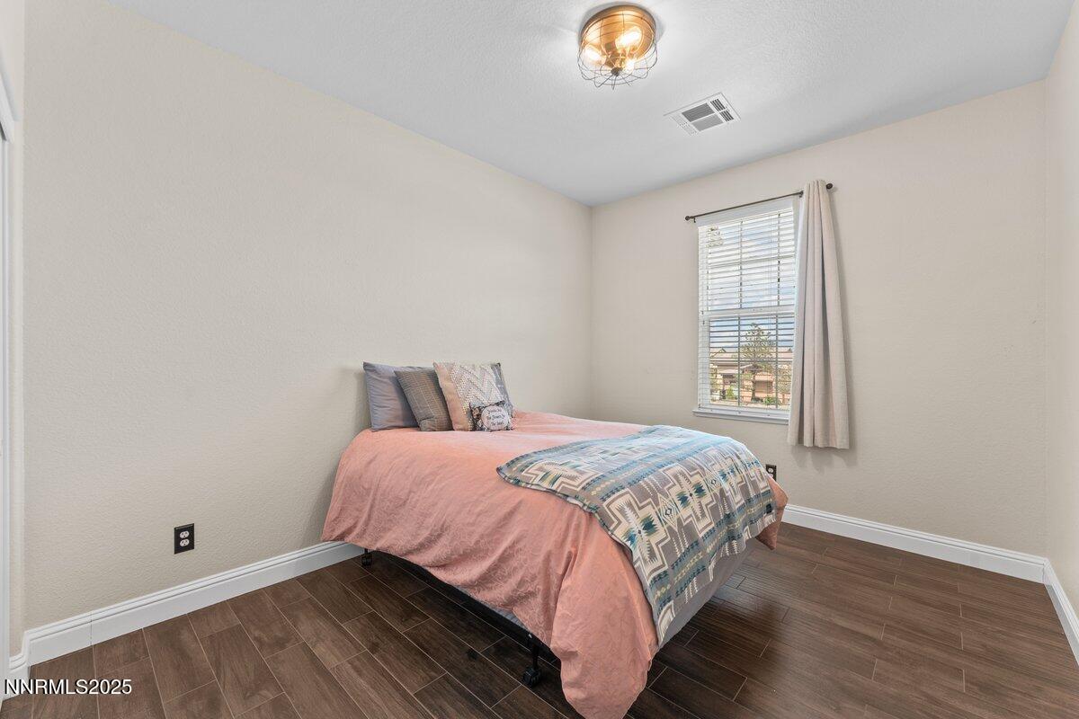 1955 Wind Ranch Road, Unit A Reno, NV 89521 - Photo 15 of 23 a bedroom with a bed and a window