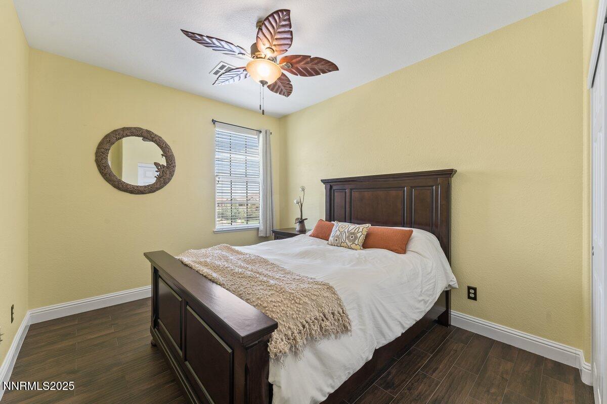 1955 Wind Ranch Road, Unit A Reno, NV 89521 - Photo 16 of 23 a bedroom with a bed and a chandelier