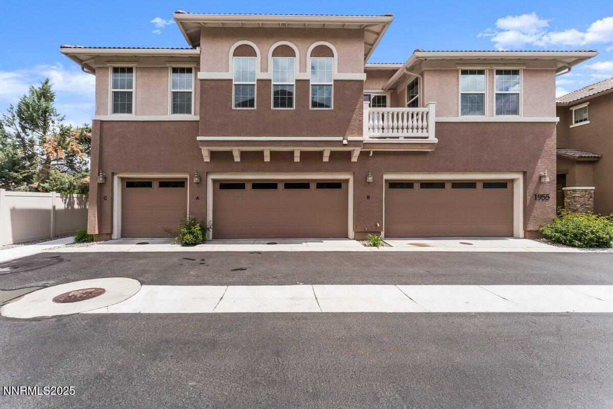 1955 Wind Ranch Road, Unit A Reno, NV 89521 - Photo 2 of 23 a front view of a house with a yard and a garage