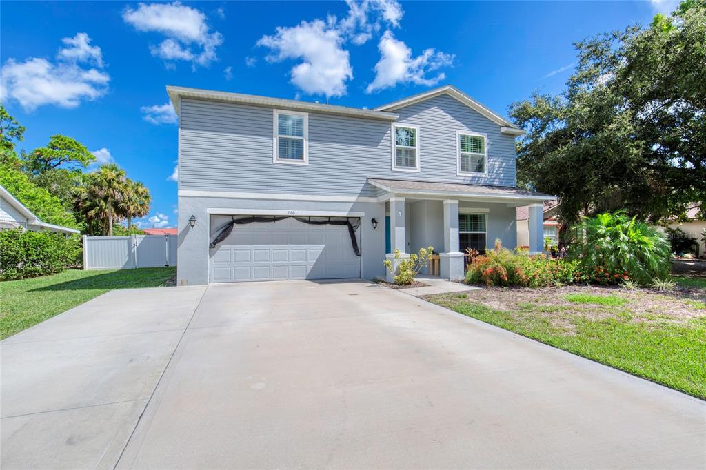 276 Farmbrook Road Port Orange, FL 32127 - Photo 2 of 62 a front view of a house with a yard and a garage