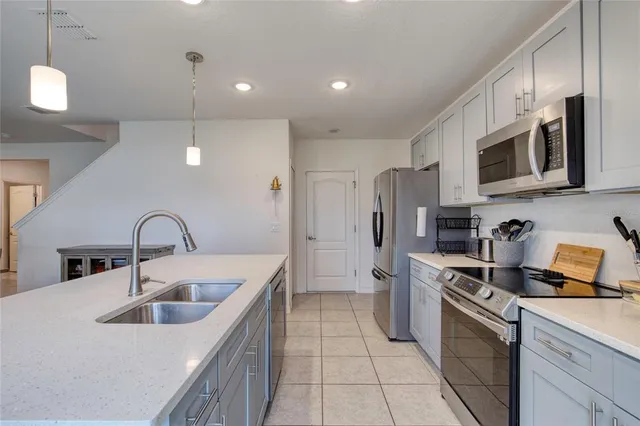 a utility room with sink dryer and washer