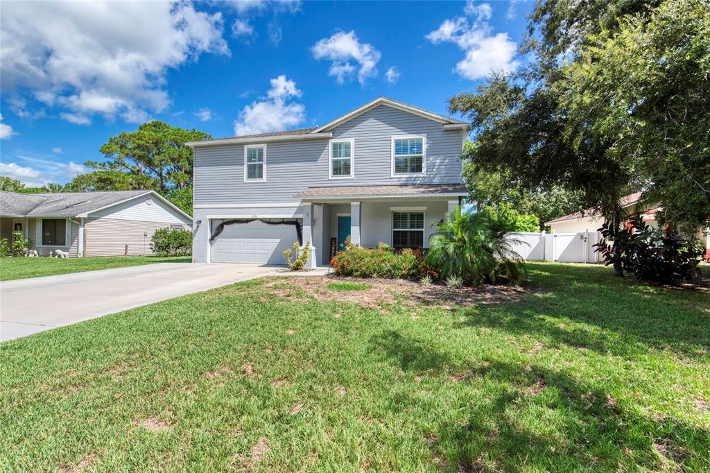 276 Farmbrook Road Port Orange, FL 32127 - Photo 3 of 62 a front view of a house with a yard and garage