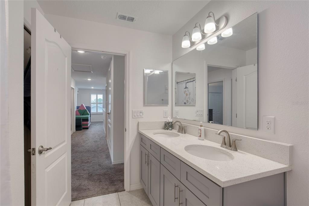 276 Farmbrook Road Port Orange, FL 32127 - Photo 31 of 62 a bathroom with a sink double vanity granite and a mirror
