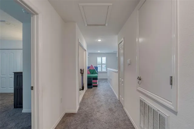 a view of bedroom with furniture and flat screen tv
