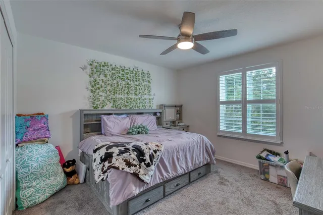 a bedroom with furniture and a flat screen tv
