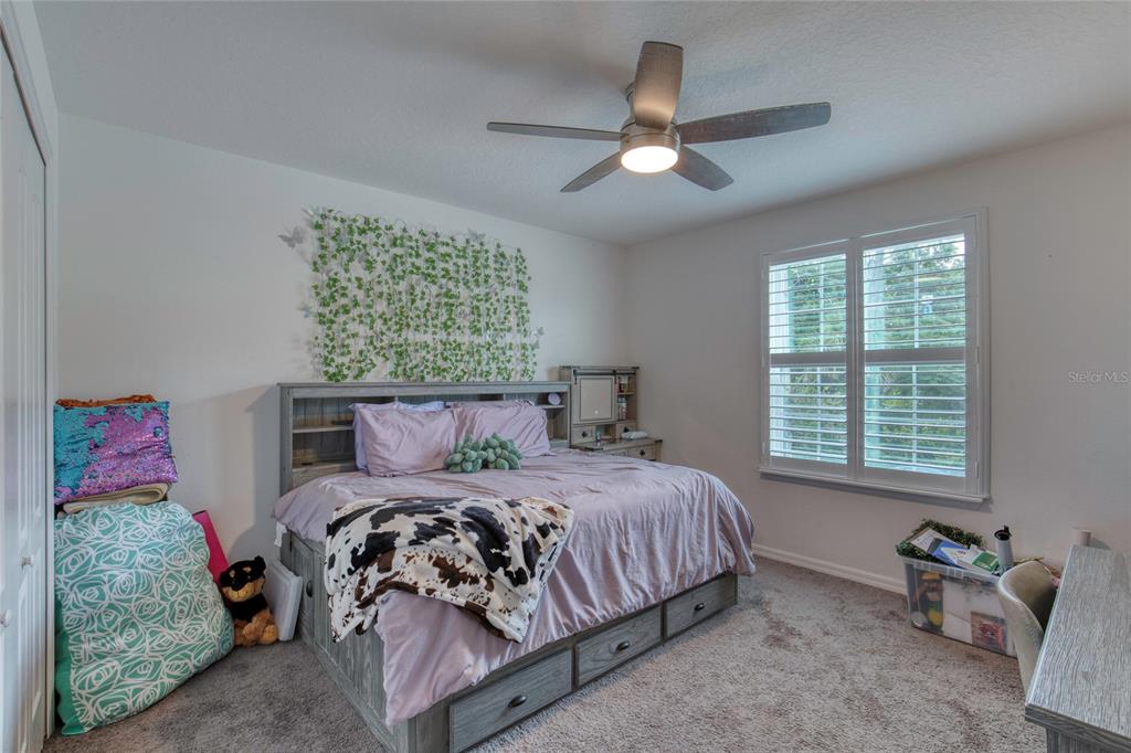 276 Farmbrook Road Port Orange, FL 32127 - Photo 33 of 62 a bedroom with a bed and a chandelier