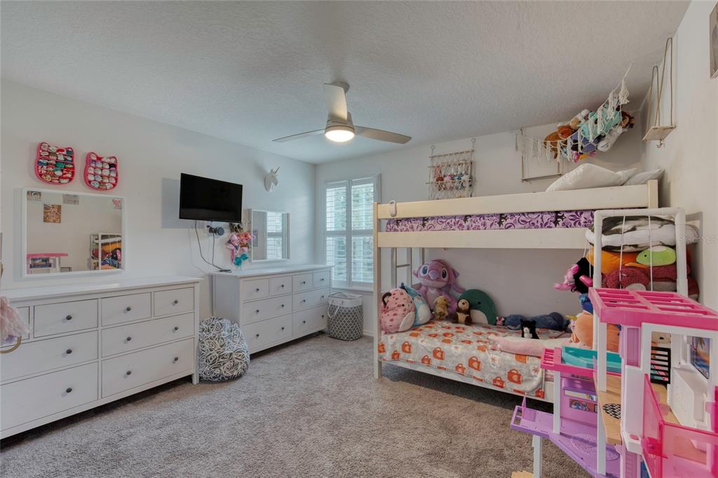 276 Farmbrook Road Port Orange, FL 32127 - Photo 37 of 62 a bedroom with furniture and a flat screen tv