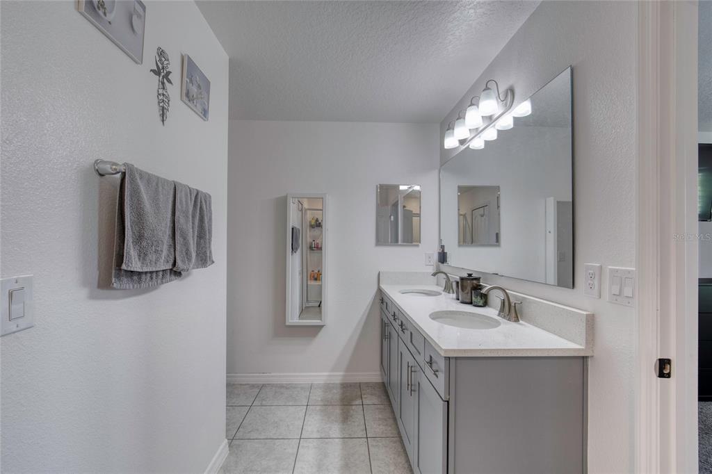 276 Farmbrook Road Port Orange, FL 32127 - Photo 42 of 62 a bathroom with a sink and a mirror