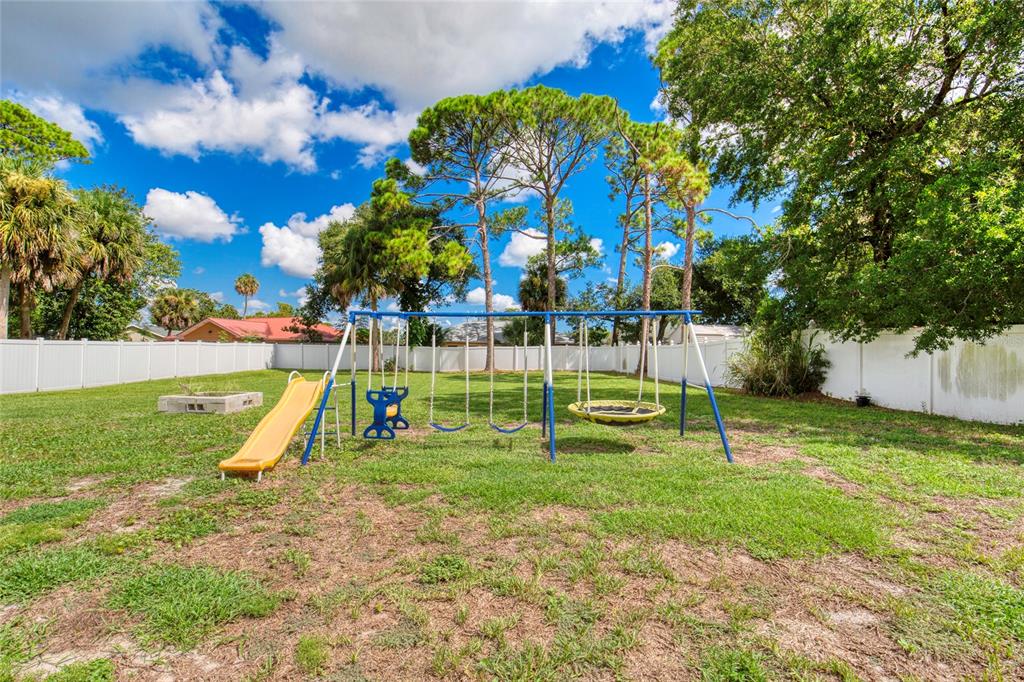 276 Farmbrook Road Port Orange, FL 32127 - Photo 45 of 62 a view of a park with swings and slides