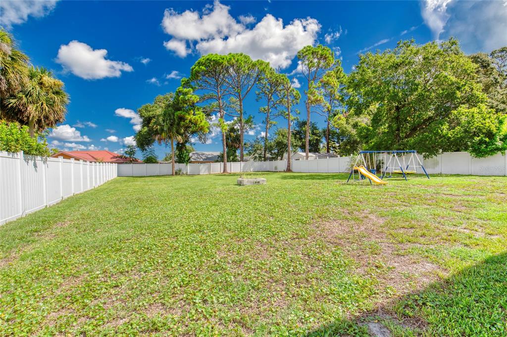 276 Farmbrook Road Port Orange, FL 32127 - Photo 46 of 62 a view of a fountain in front of a house with a big yard