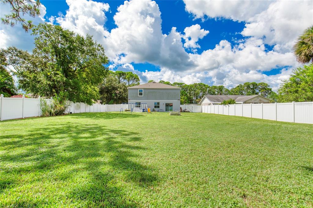 276 Farmbrook Road Port Orange, FL 32127 - Photo 48 of 62 a view of a house with a big yard