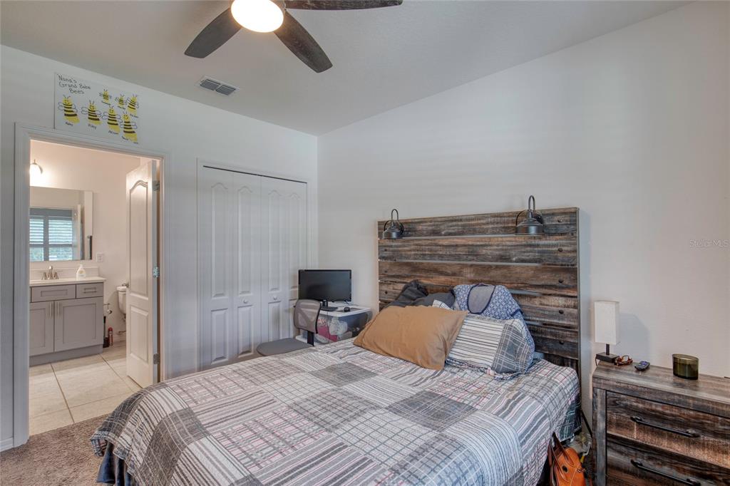 276 Farmbrook Road Port Orange, FL 32127 - Photo 8 of 62 a bedroom with a bed and a chandelier