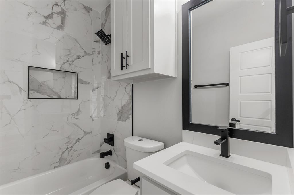 1616 Monroe Street Wichita Falls, TX 76309 - Photo 15 of 21 a bathroom with a sink a toilet and shower