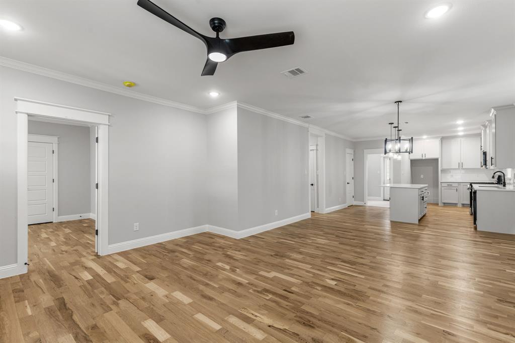 1616 Monroe Street Wichita Falls, TX 76309 - Photo 4 of 21 a view of an empty room with kitchen and a window