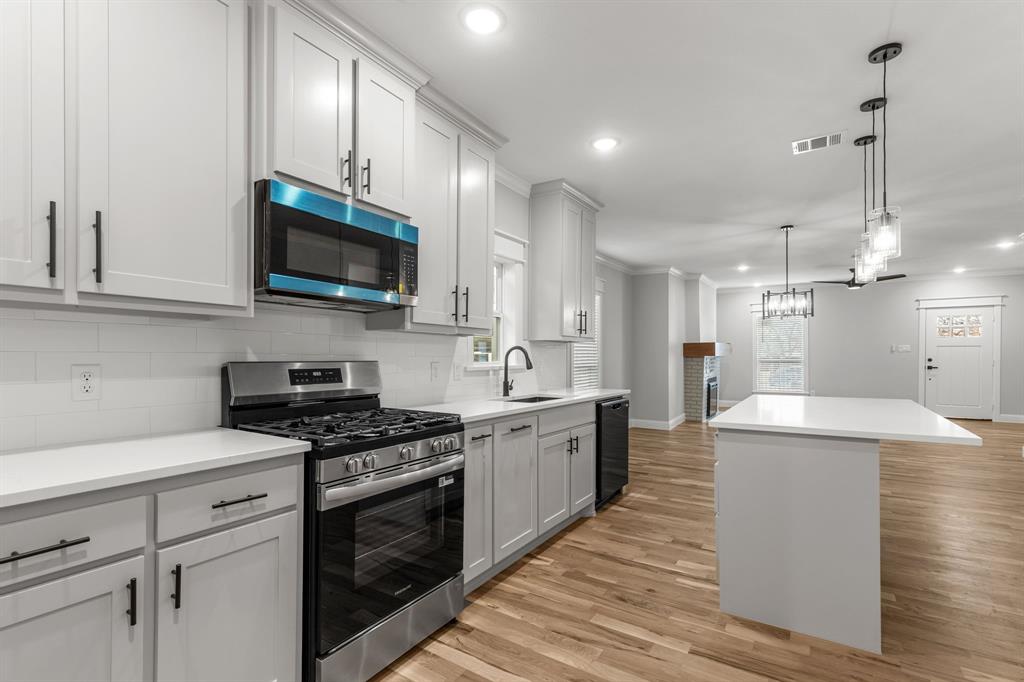 1616 Monroe Street Wichita Falls, TX 76309 - Photo 5 of 21 a kitchen with stainless steel appliances a stove sink microwave and cabinets