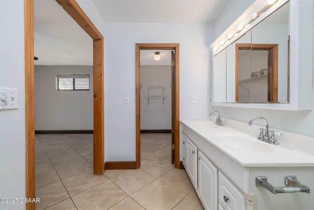 a bathroom with 2 sink and a mirror