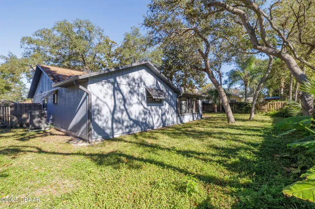 a view of a backyard with a table and chairs