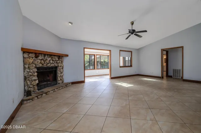 a view of a livingroom with a fireplace and window