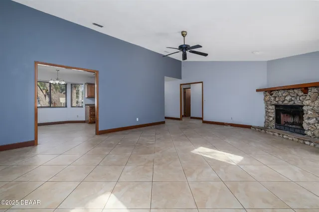 a view of a livingroom with a fireplace and a chandelier