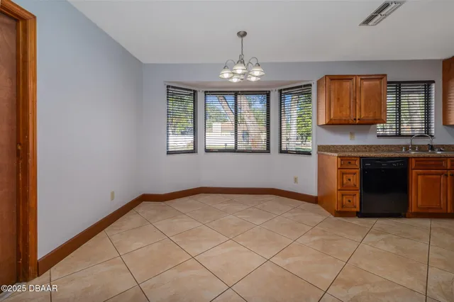 a view of a kitchen with granite countertop cabinets and outdoor space