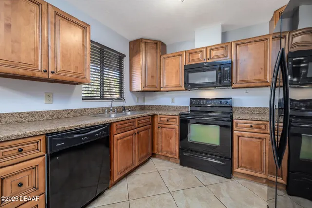 a kitchen with stainless steel appliances granite countertop a stove microwave and refrigerator