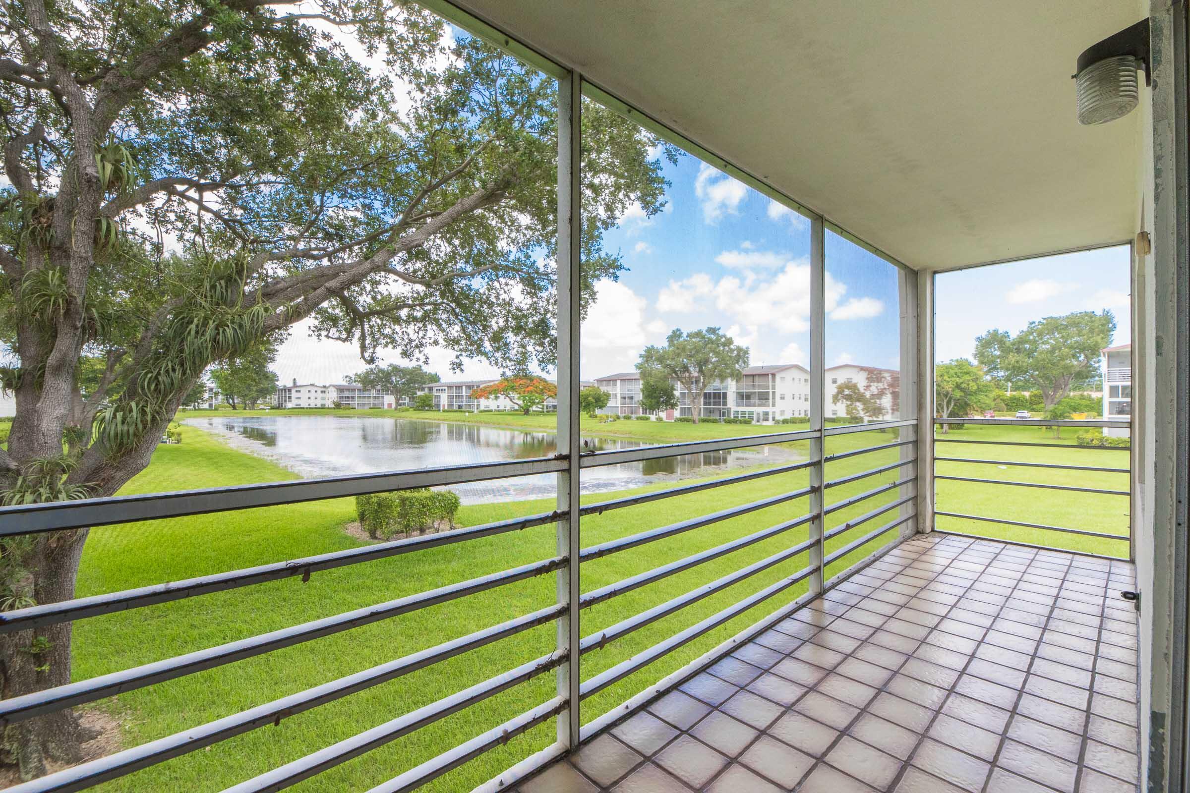 402 Fanshaw J Boca Raton, FL 33434 - Photo 12 of 18 Screened Patio with Lake View