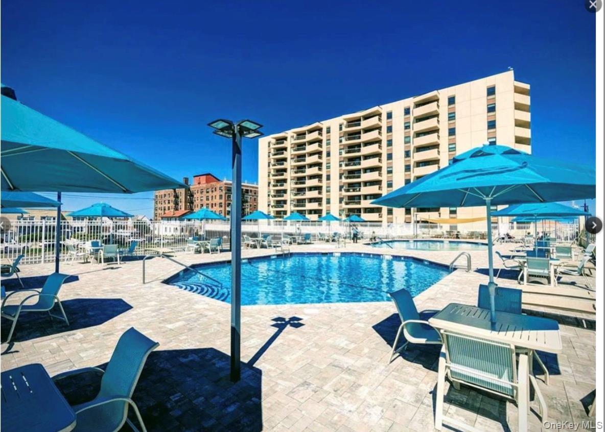 360 Shore Road, Unit 3D Long Beach, NY 11561 - Photo 11 of 11 a view of a patio with a table chairs and a umbrella