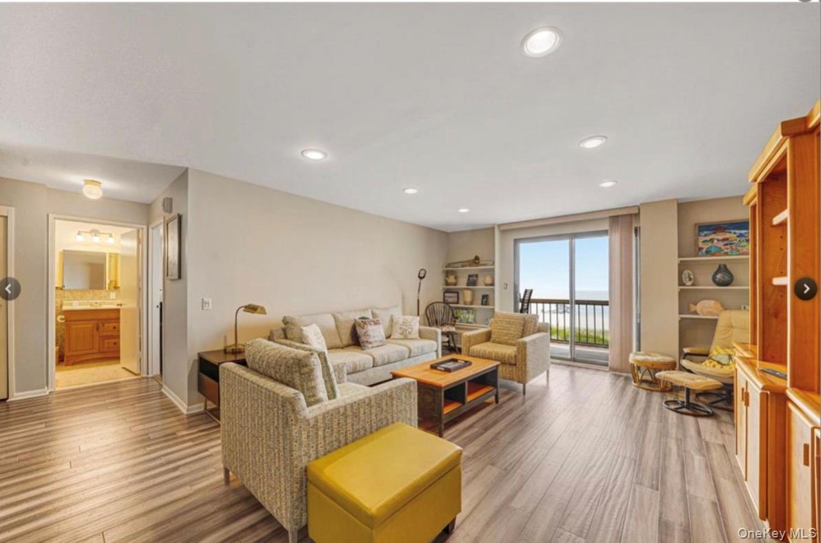360 Shore Road, Unit 3D Long Beach, NY 11561 - Photo 4 of 8 a living room with furniture and a wooden floor