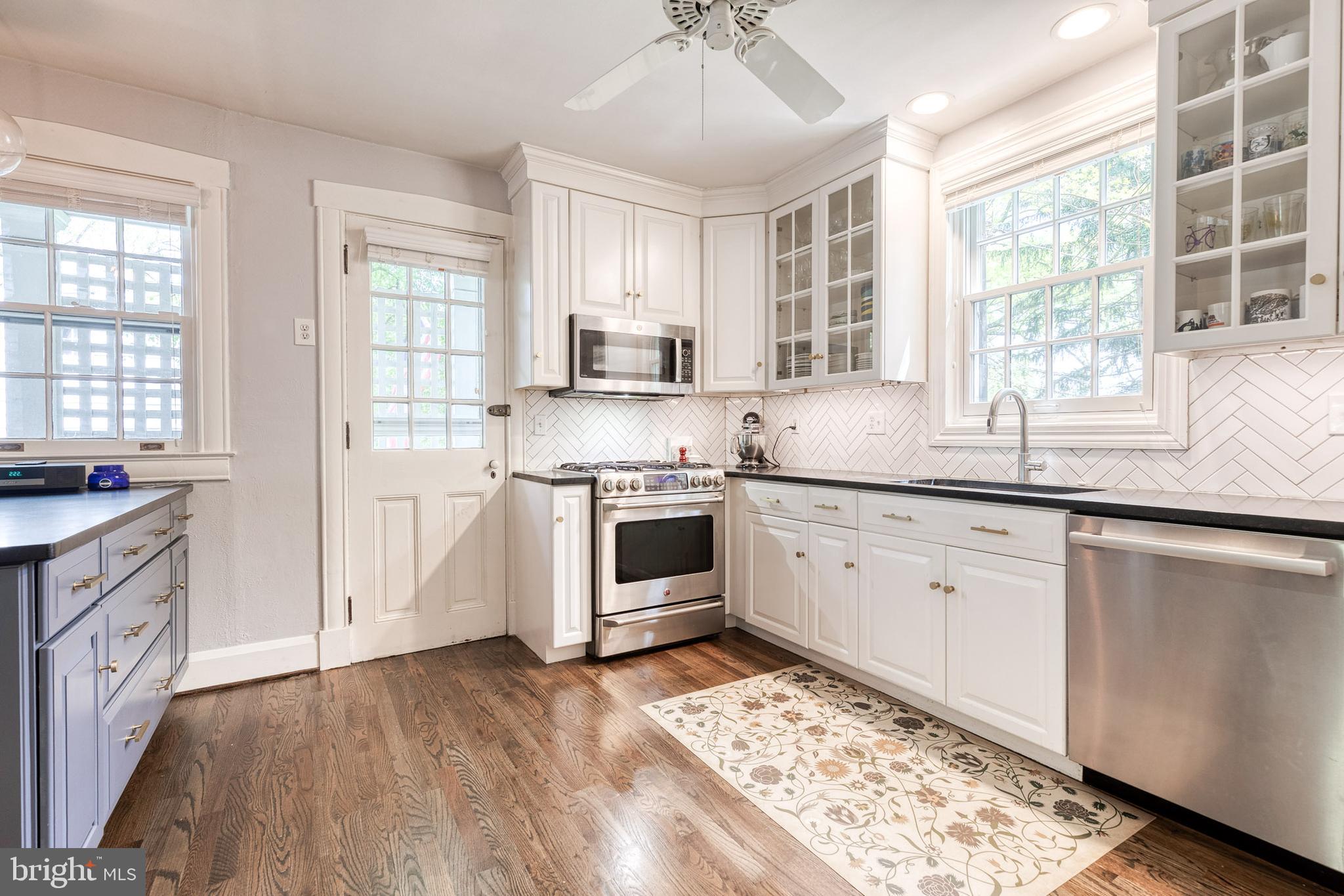 225 Tunbridge Road Baltimore, MD 21212 - Photo 31 of 65 a kitchen with granite countertop white cabinets and white appliances