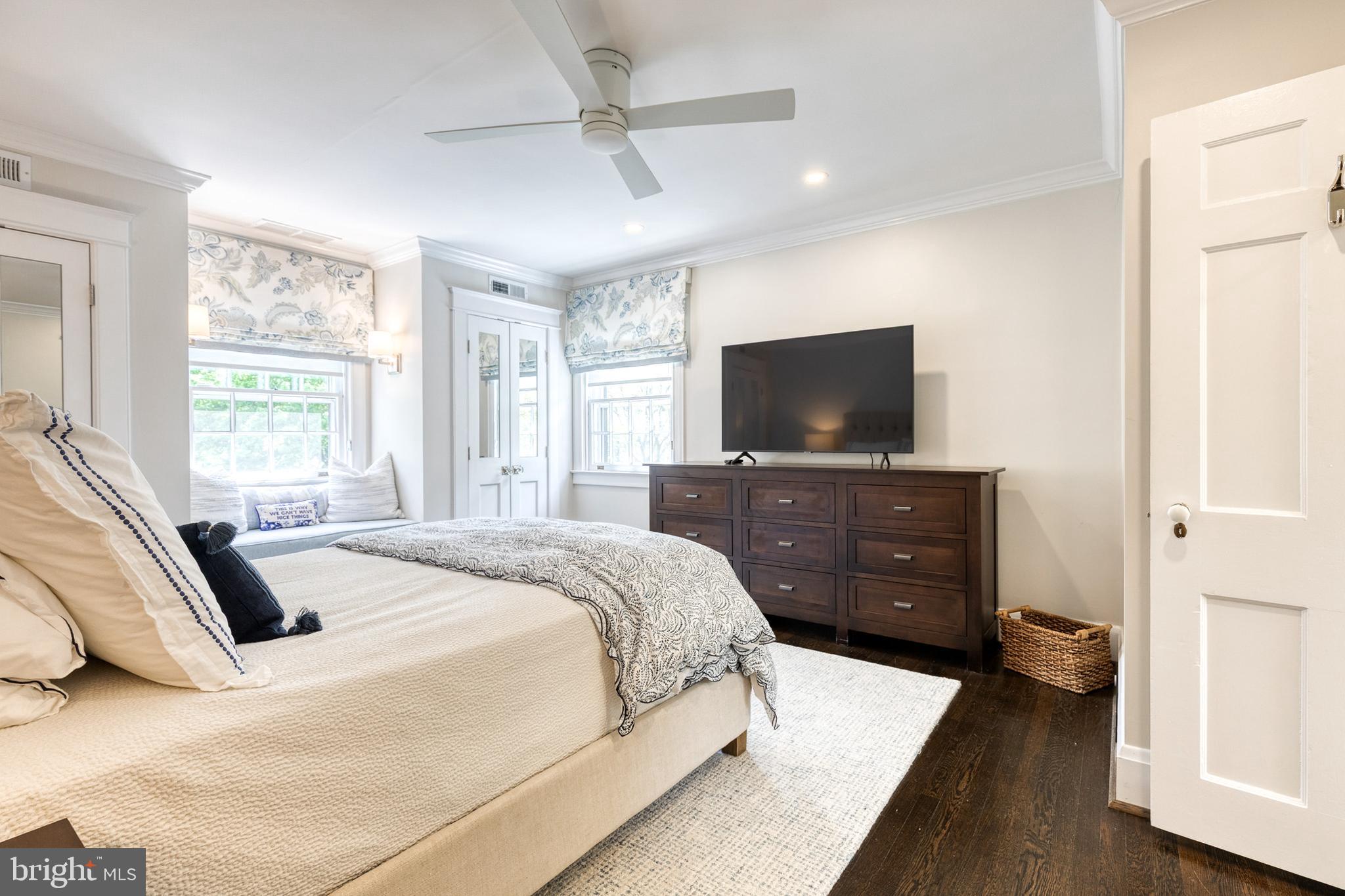 225 Tunbridge Road Baltimore, MD 21212 - Photo 34 of 65 a spacious bedroom with a bed and a flat screen tv