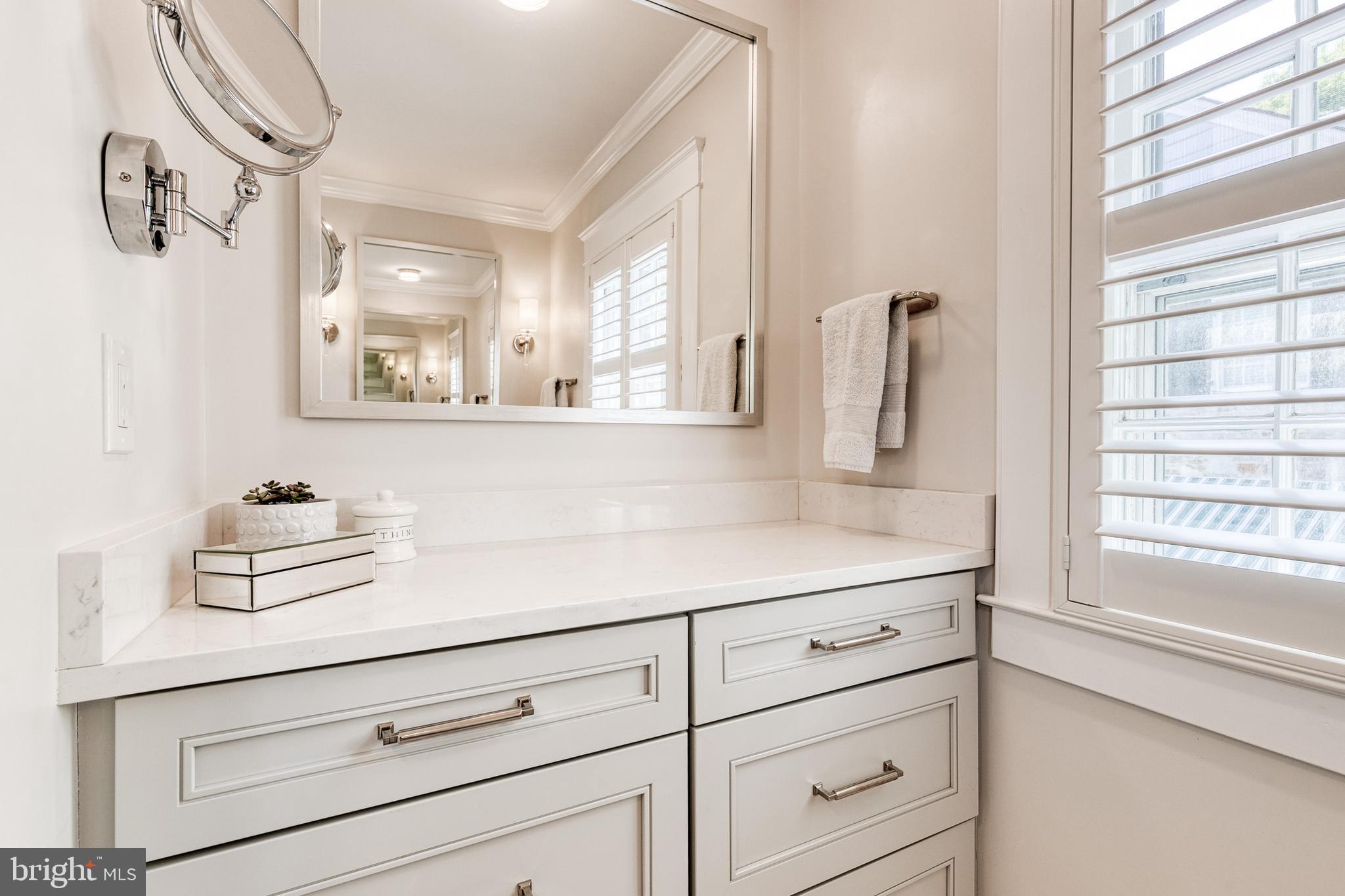 225 Tunbridge Road Baltimore, MD 21212 - Photo 40 of 65 a bathroom with a sink and a mirror next to a window
