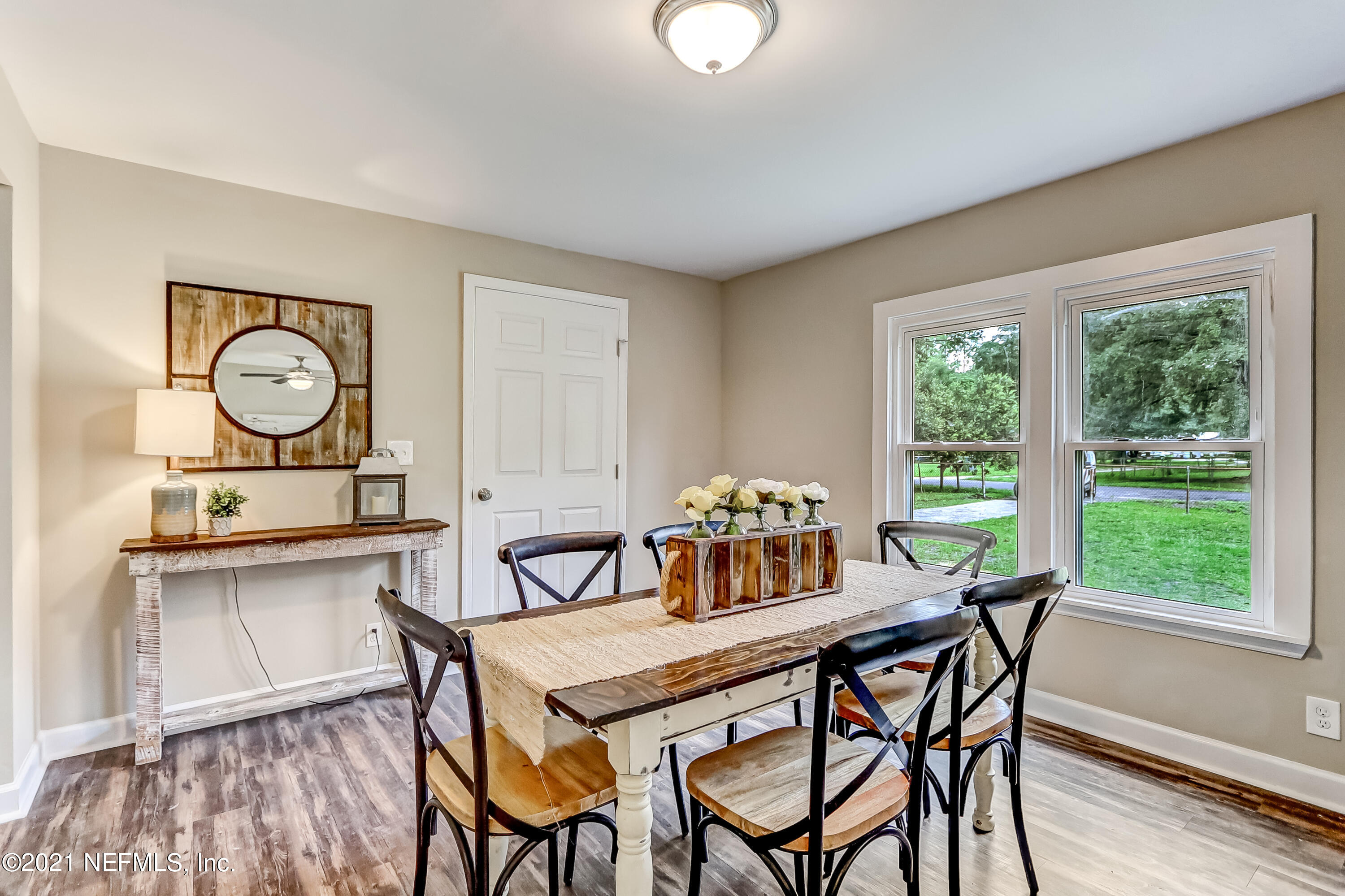 1416 Fred Gray Road Jacksonville, FL 32218 - Photo 15 of 34 a view of a dining room with furniture window and wooden floor
