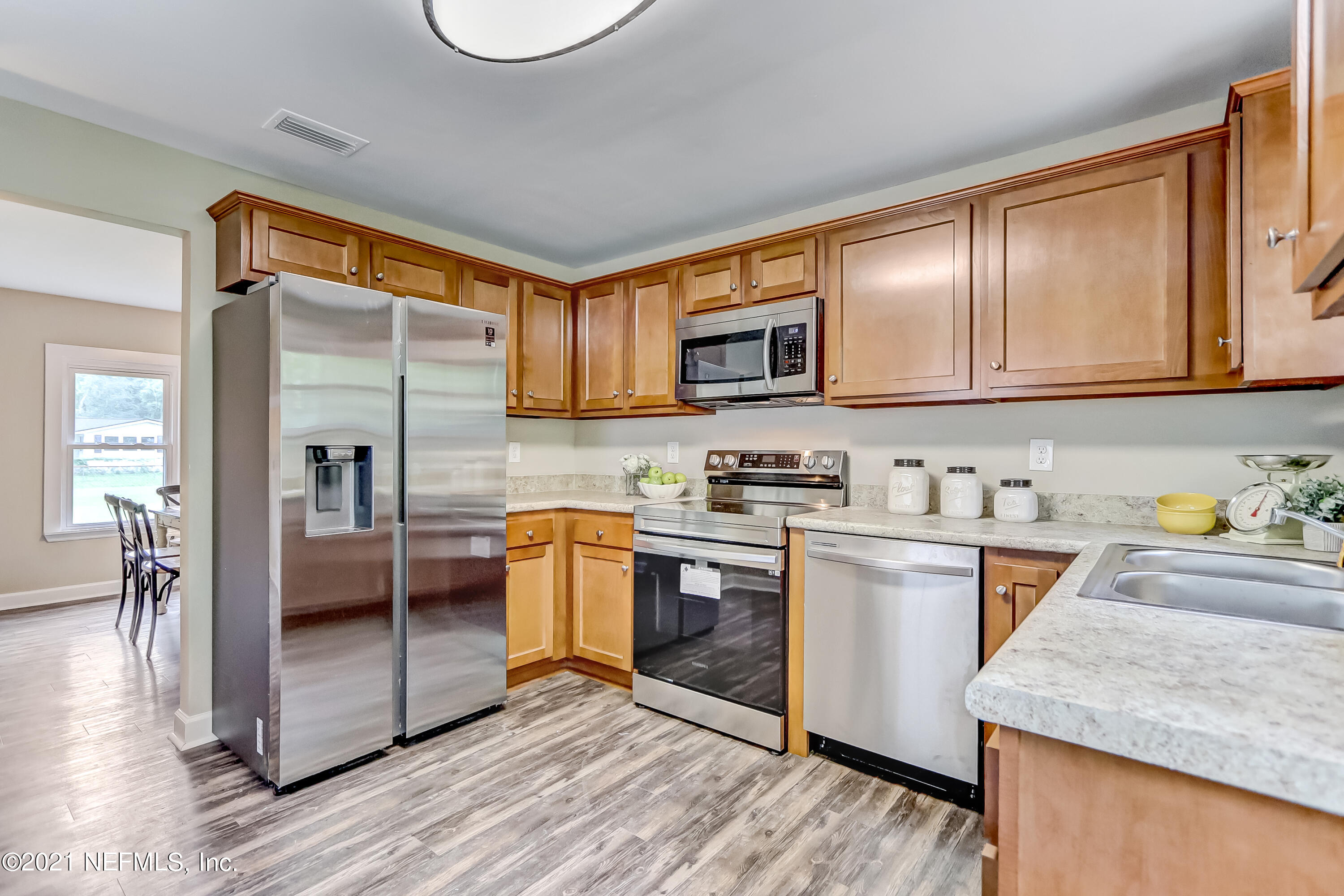 1416 Fred Gray Road Jacksonville, FL 32218 - Photo 20 of 34 a kitchen with stainless steel appliances granite countertop a refrigerator stove and sink